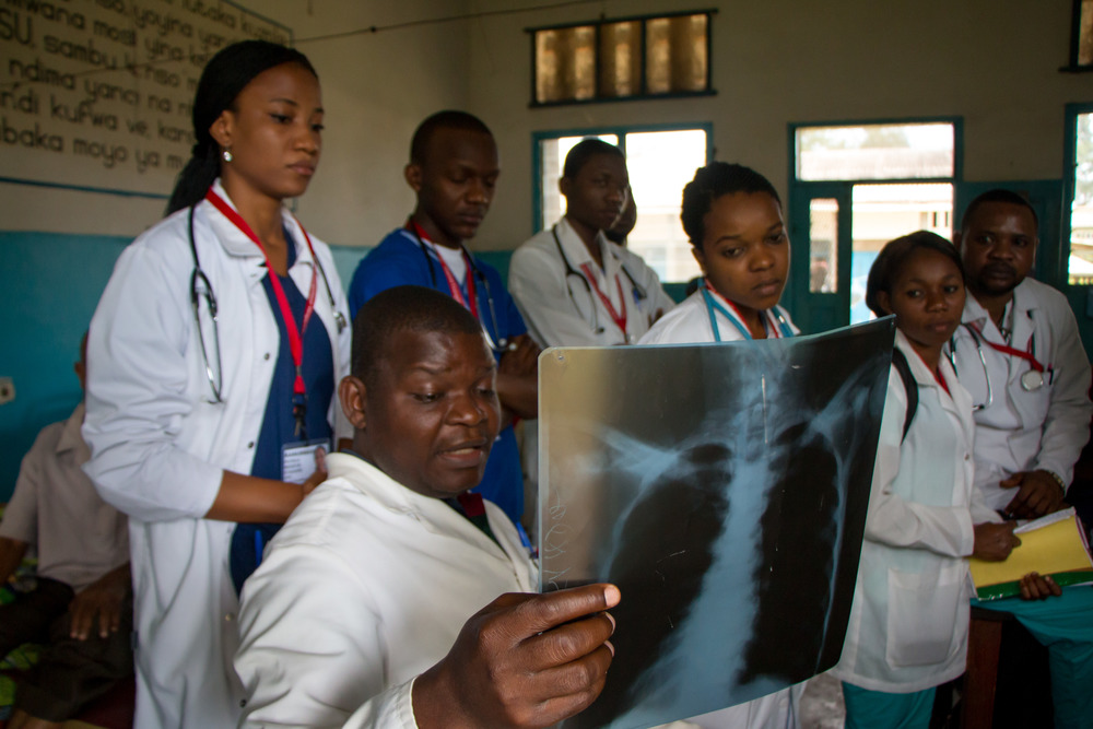 Vanga medical personnel examine an x-ray. Photo by Mark & Kelly Hewes.