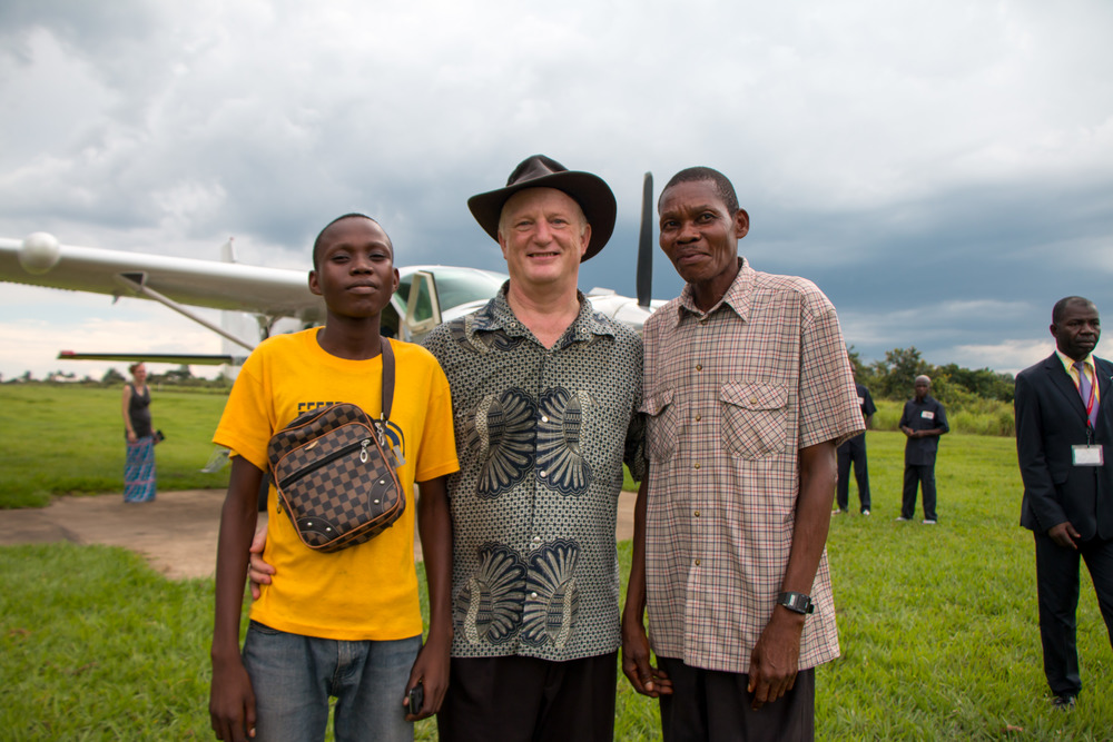 Plamedie after treatment, with his father (right) and Dr. Tim Rice (center).
