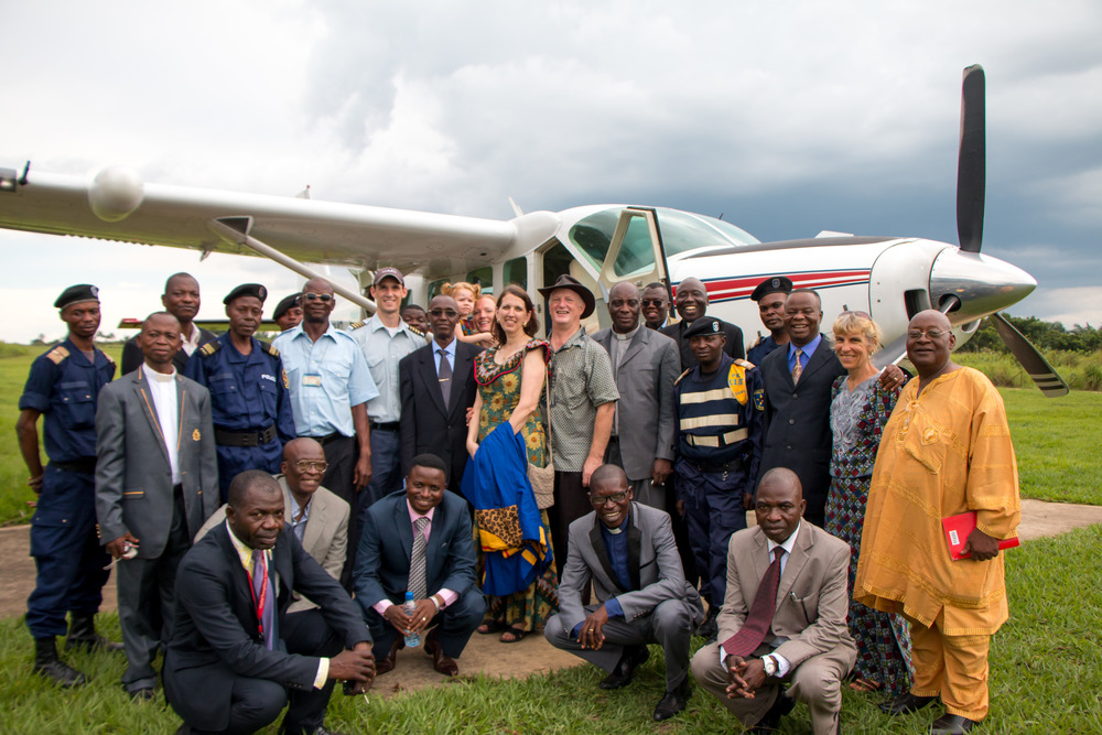 Dr. Tim and Kathy Rice (center) with pilot Nick Frey (center, left) with missionaries and other delegates who were flown to Vanga for the opening of the new nursing school building. Photo by Mark & Kelly Hewes.