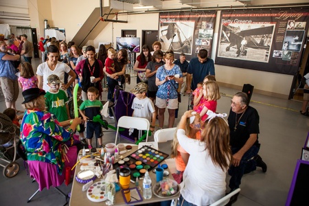 Lisa Byce and Diana Finnigan from Clown Connection decorate faces and make balloon creatures at MAF’s 70th anniversary celebration. Some 600 people attended the event Saturday at the Nampa airport. Photo by Paul O’Brien.