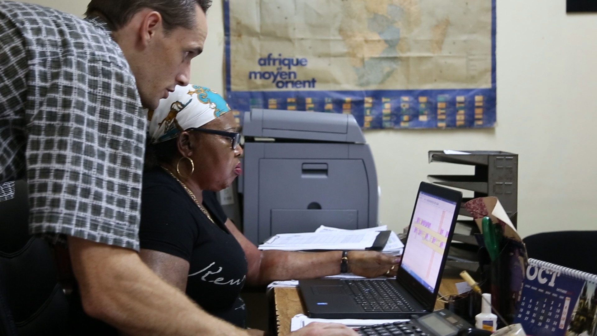 Program Manager Nick Frey and an MAF staff member help coordinate flights. Photo by Mark and Kelly Hewes.