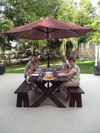 Linda and Lee Calhoun, Laura Persenarie’s parents, enjoy a tropical Thanksgiving feast with Laura’s family in Tarakan.