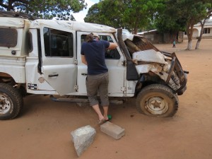 Jill Holmes inspecting her wrecked vehicle.