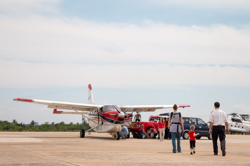 Rebecca (in background, red top) arriving in Palangkaraya and about to be greeted by her new teammates.
