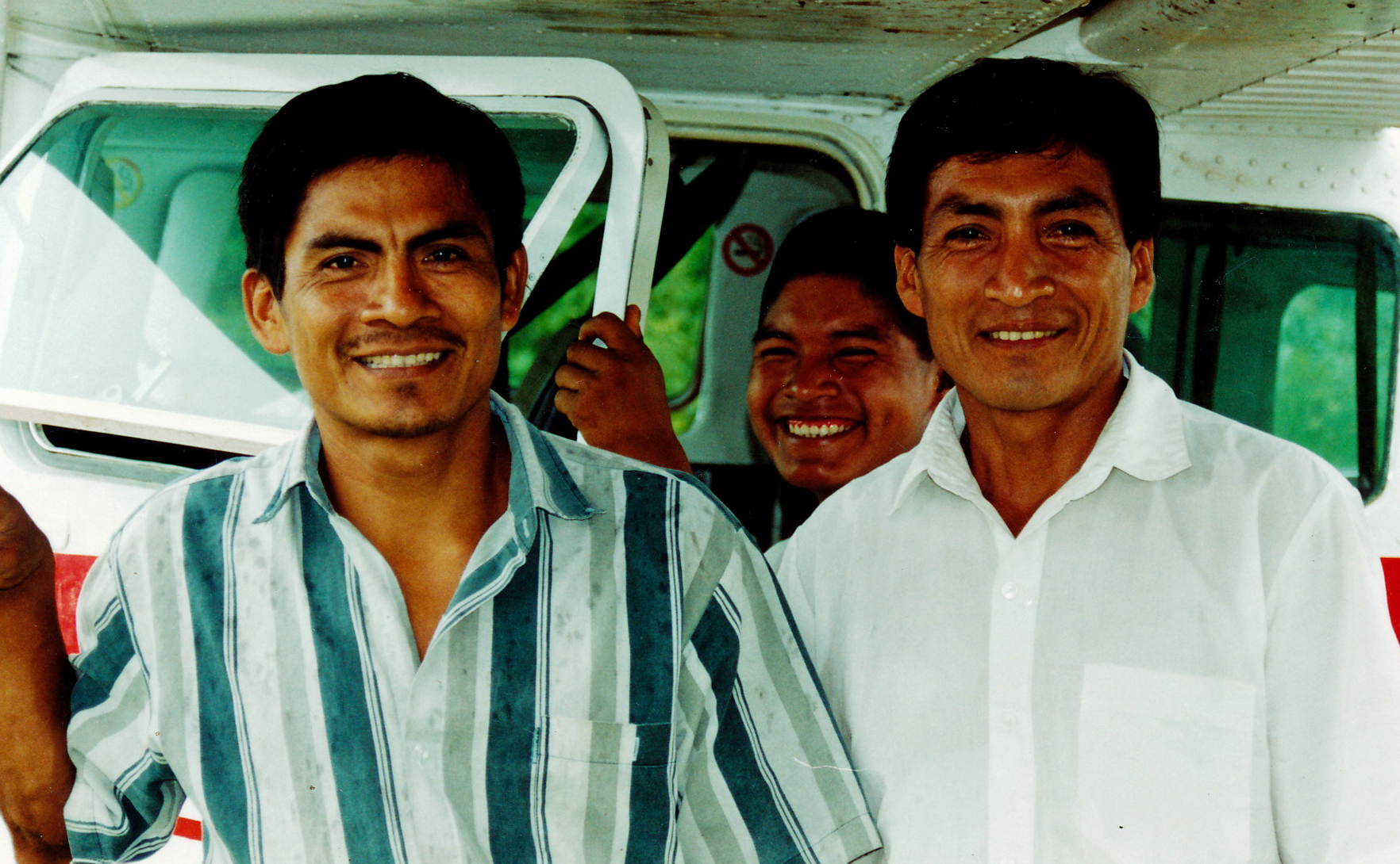 wo Shuar evangelists meet the airplane in the village of Yuvientza.