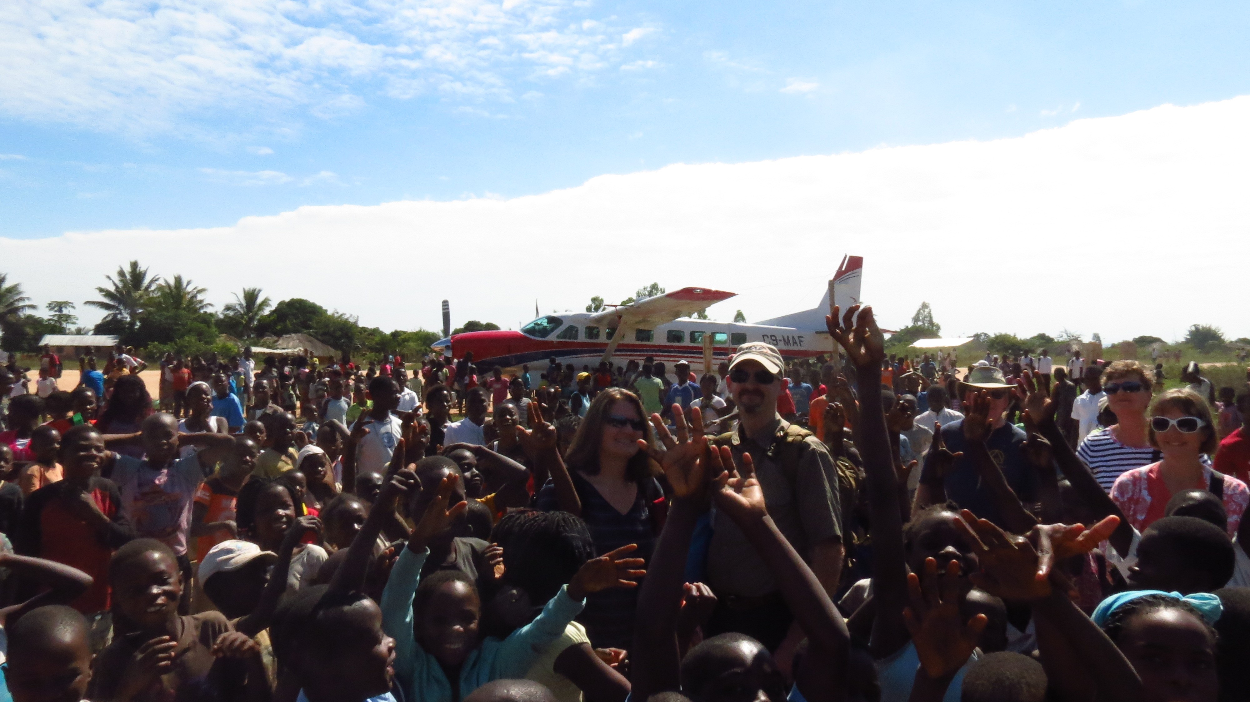 Jill and her husband-pilot Dave engulfed by the crowd at Mocuba. Photo courtesy of the Holmes.