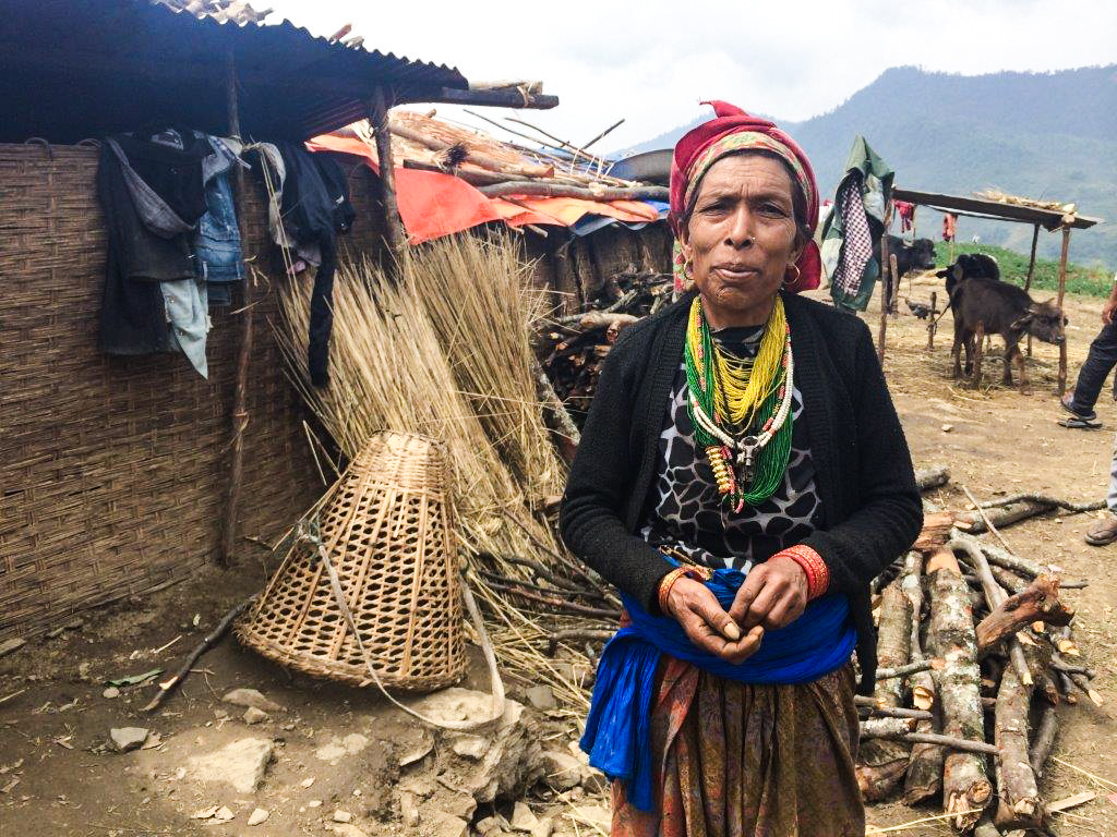 Sixty-year old Suku B.K. stands in front of temporary shelters .