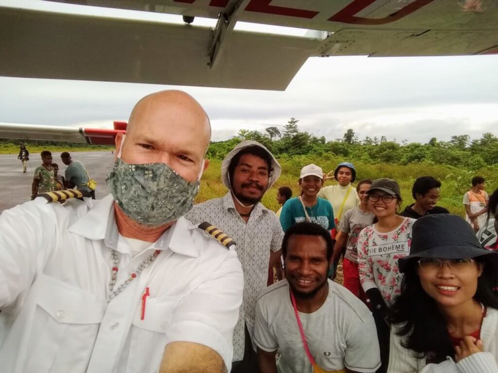 mission aviation fellowship charity pilot delivers supplies to teachers in a remote village